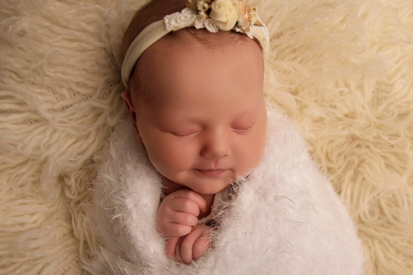 Newborn baby girl asleep with a floral headband, Portlaoise studio
